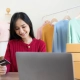 Startup, petite entreprise, PME, femme asiatique emballant du tissu dans une boîte. Carte